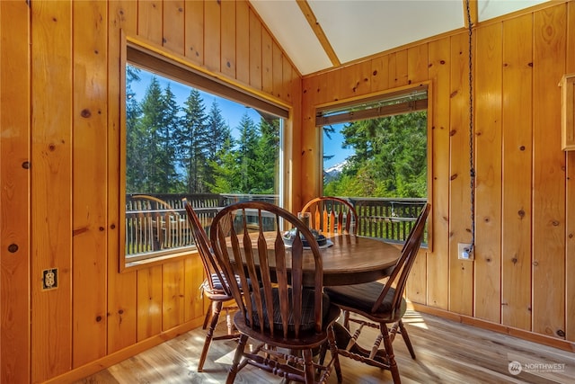 252 Snyder Rd, Packwood, WA 98361 - dining space with a healthy amount of sunlight, light hardwood / wood-style floors, vaulted ceiling, and wooden walls