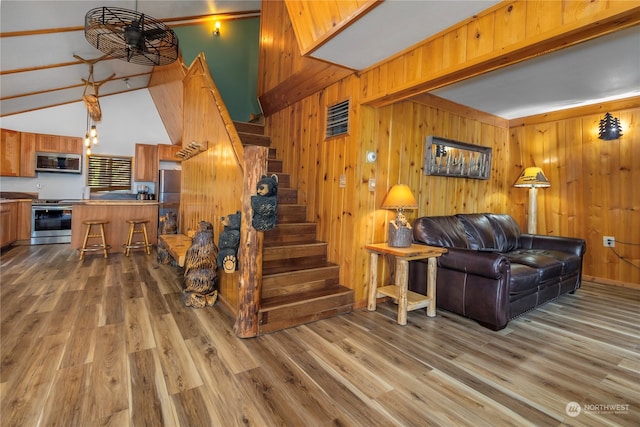 252 Snyder Rd, Packwood, WA 98361 - stairs featuring wooden walls, hardwood / wood-style flooring, and vaulted ceiling