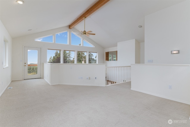 unfurnished living room featuring light carpet, beamed ceiling, ceiling fan, and high vaulted ceiling