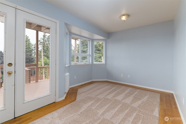 interior space with french doors, radiator, and light hardwood / wood-style floors