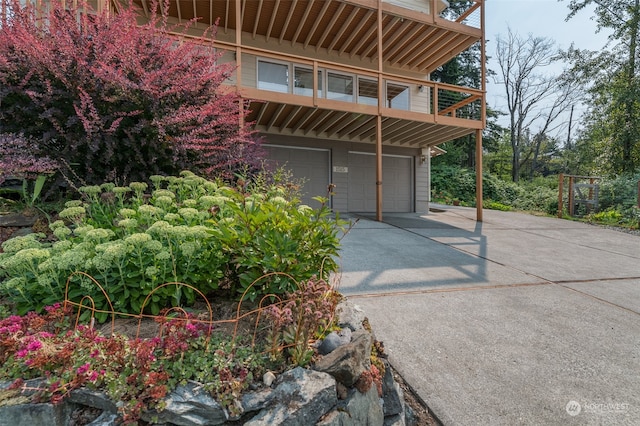 view of front of home featuring a balcony and a garage