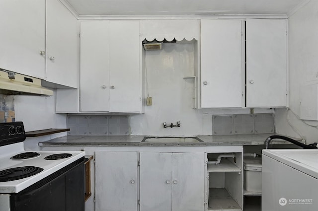 kitchen featuring washer / dryer, sink, white cabinets, tasteful backsplash, and range with electric cooktop