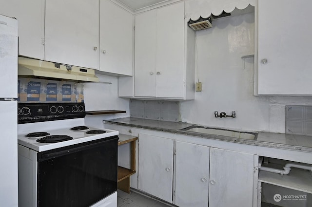 kitchen featuring electric stove, white cabinets, sink, and tasteful backsplash