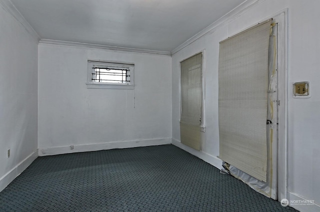 spare room with dark carpet and ornamental molding