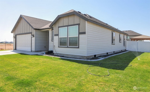 view of front facade with a front lawn, a garage, and board and batten siding