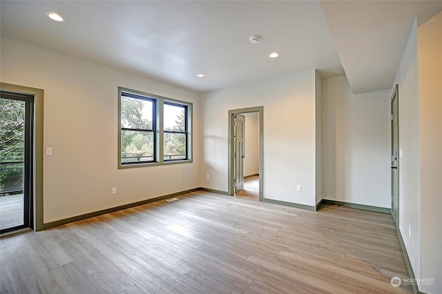 empty room with light hardwood / wood-style flooring