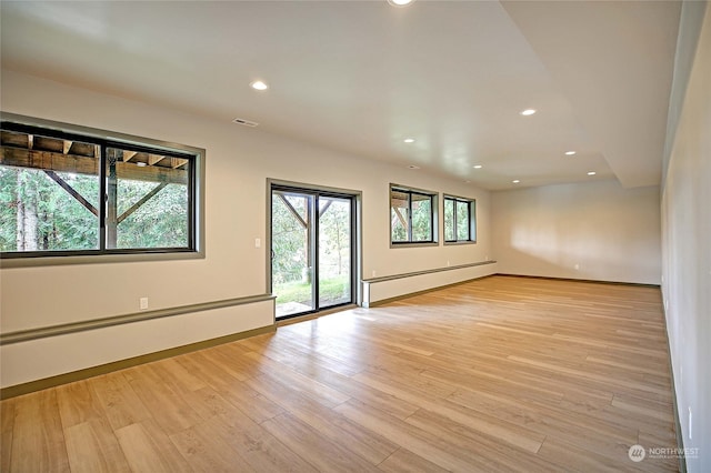 empty room with light hardwood / wood-style floors