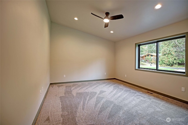 empty room with ceiling fan and carpet flooring