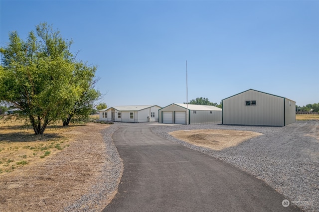 view of front facade featuring an outdoor structure and a garage