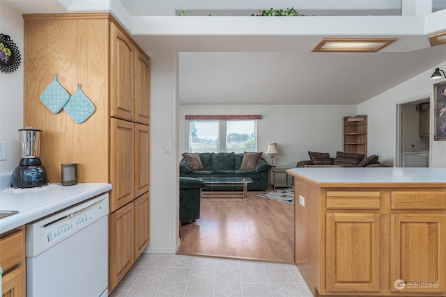 kitchen featuring light wood-type flooring, kitchen peninsula, and white dishwasher