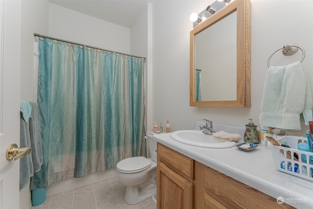 bathroom with vanity, toilet, and tile patterned floors