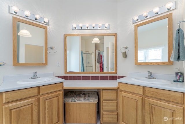 bathroom featuring vanity and a shower with shower door