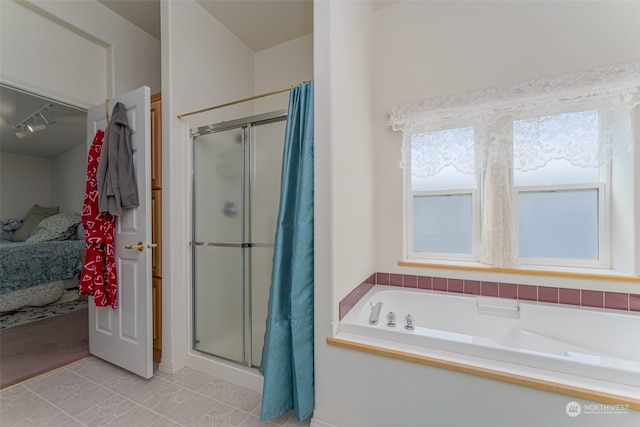 bathroom featuring plus walk in shower and tile patterned flooring