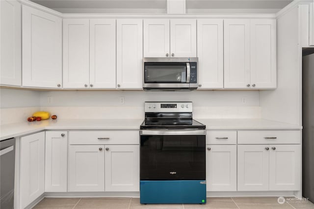 kitchen with stainless steel appliances and white cabinetry