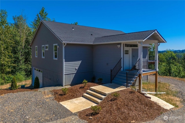 view of front facade with covered porch and a garage