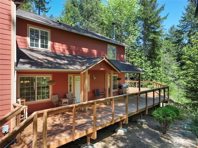 rear view of property featuring a deck