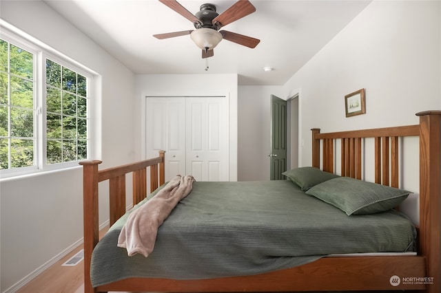 bedroom with a closet, ceiling fan, and wood-type flooring