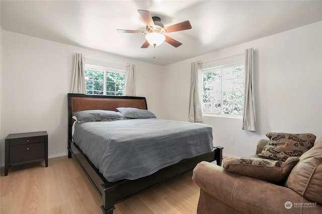 bedroom featuring multiple windows, light wood-type flooring, and ceiling fan