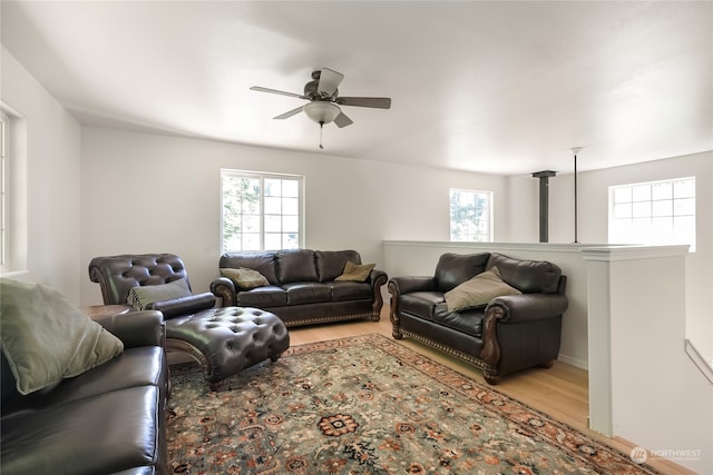 living room featuring ceiling fan and light hardwood / wood-style flooring