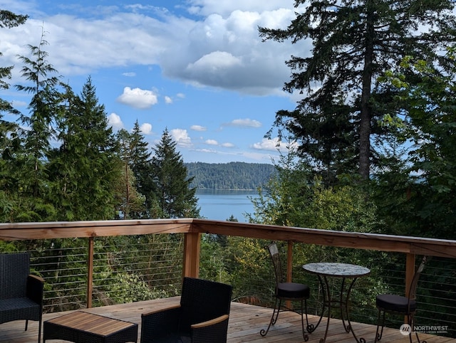 wooden terrace featuring a water view