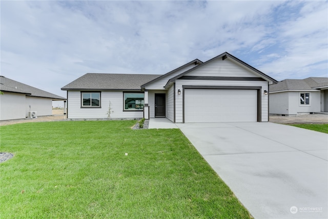 ranch-style house with a garage and a front yard