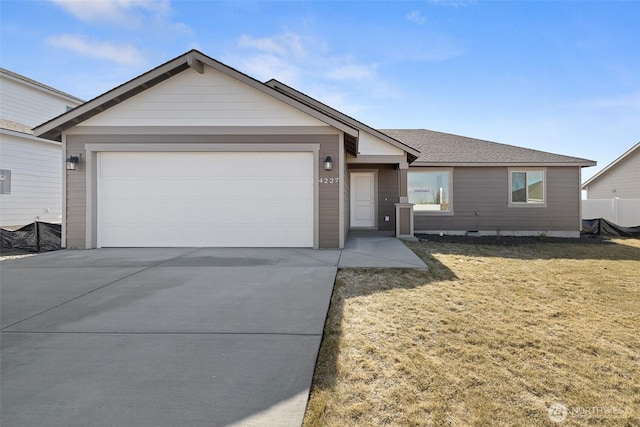 ranch-style house with driveway, a garage, a shingled roof, crawl space, and a front yard