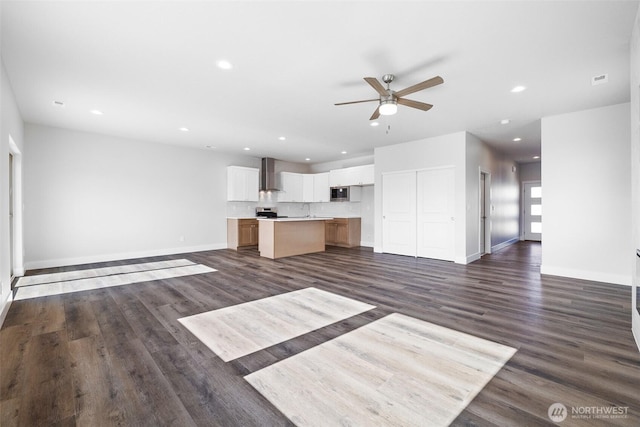 unfurnished living room featuring dark wood-style floors, baseboards, a ceiling fan, and recessed lighting