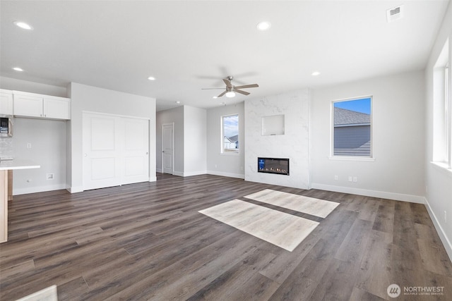 unfurnished living room with dark wood finished floors, a tile fireplace, visible vents, and recessed lighting