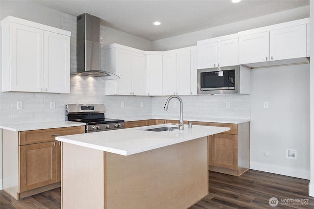 kitchen with electric range, dark wood-type flooring, a sink, built in microwave, and wall chimney exhaust hood