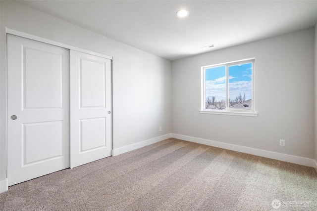 unfurnished bedroom with visible vents, baseboards, carpet flooring, a closet, and recessed lighting