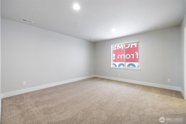 carpeted empty room featuring recessed lighting, visible vents, and baseboards