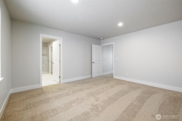 carpeted empty room with baseboards and recessed lighting