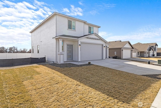 traditional-style house with driveway, a front yard, and fence