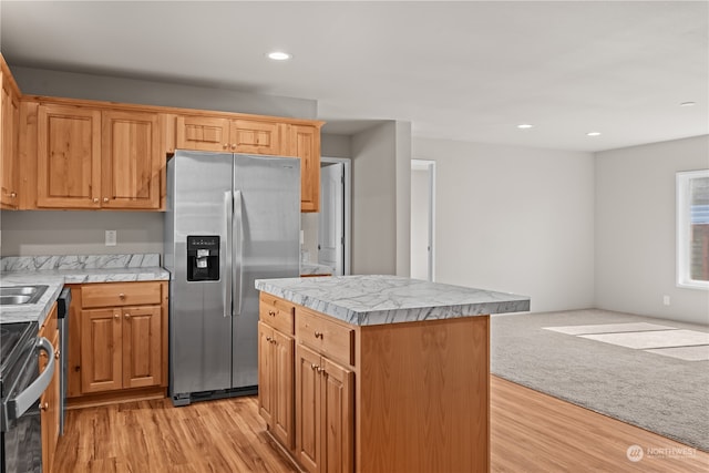 kitchen featuring light hardwood / wood-style floors, a kitchen island, and stainless steel appliances