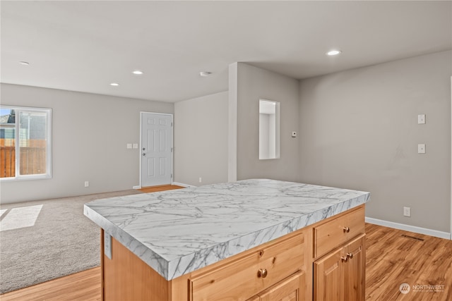 kitchen with a center island and light wood-type flooring