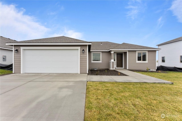 ranch-style home featuring a garage and a front lawn