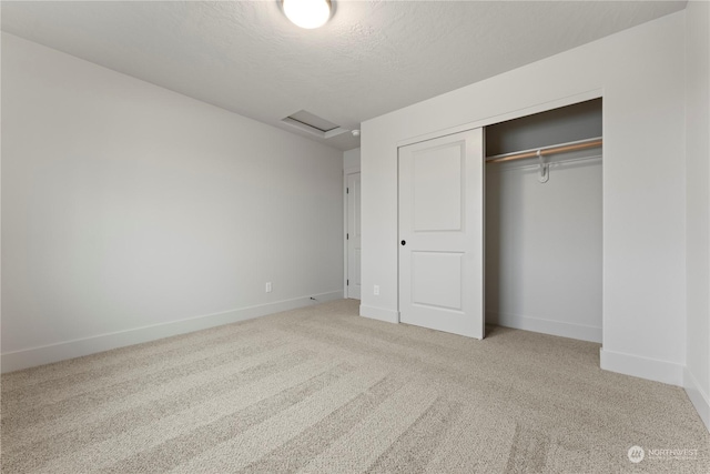 unfurnished bedroom with carpet flooring, a closet, and a textured ceiling