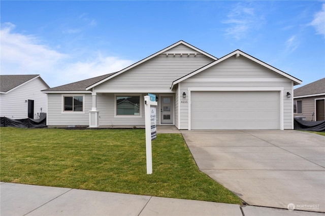 ranch-style house featuring a front lawn and a garage