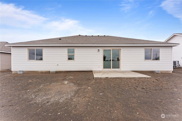 rear view of house with central air condition unit and a patio