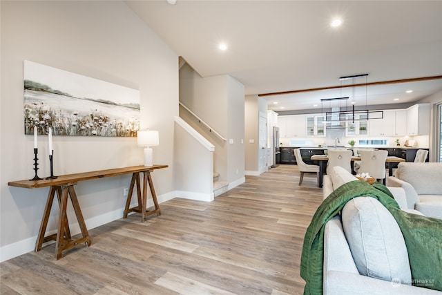 living room with sink and light hardwood / wood-style flooring