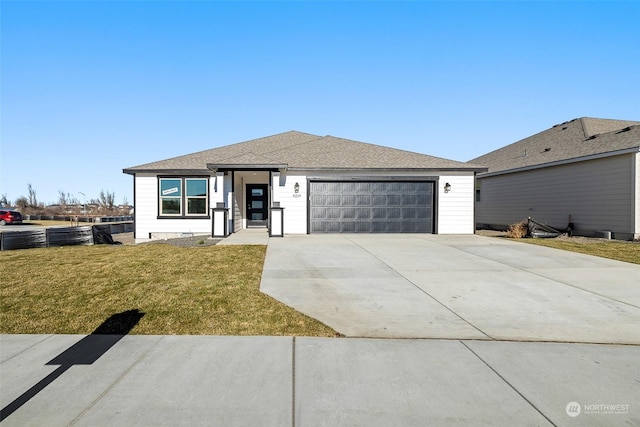 view of front of house featuring a garage and a front lawn