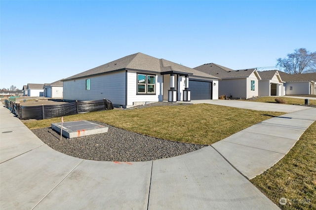 view of front of property with a garage and a front lawn