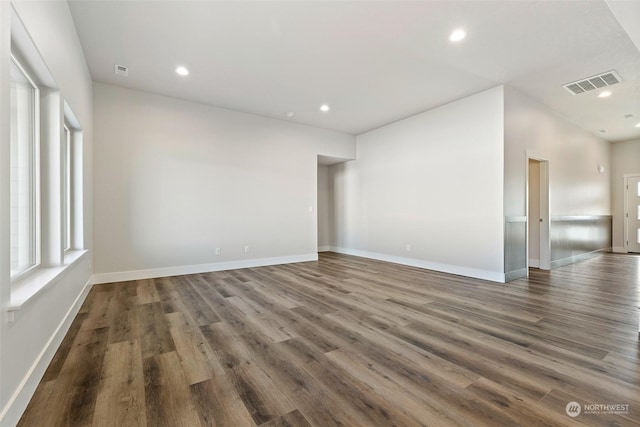 spare room with dark wood-type flooring