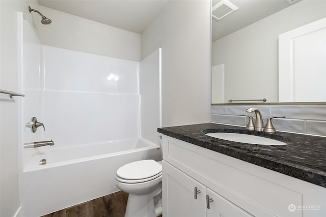 full bathroom with vanity, toilet, hardwood / wood-style floors, and shower / bathing tub combination