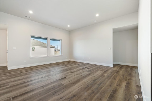 empty room with dark wood-type flooring