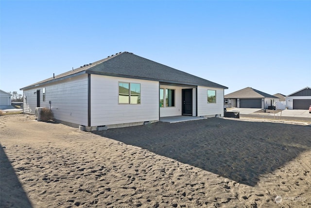 rear view of property with a garage