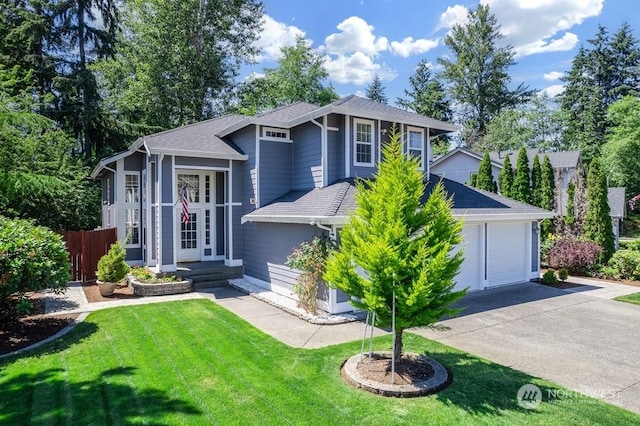 view of front of home featuring a garage and a front lawn