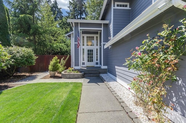 doorway to property featuring a lawn