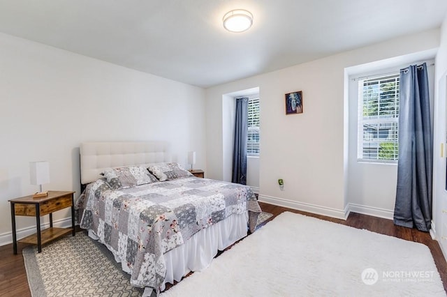 bedroom with dark hardwood / wood-style flooring