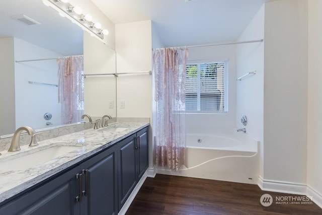 bathroom with shower / bath combo with shower curtain, vanity, and wood-type flooring